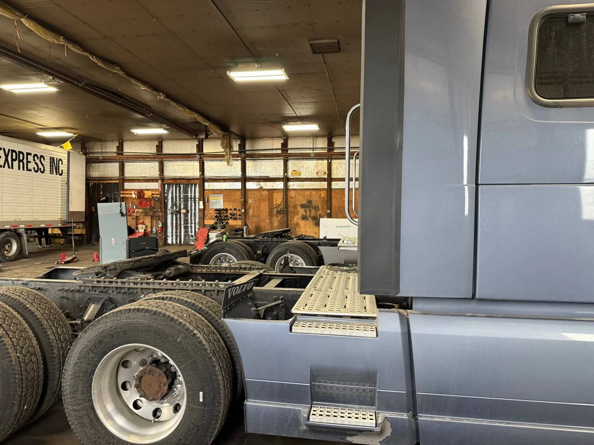 Semi trucks in for service inside the Soft Trans Auto shop